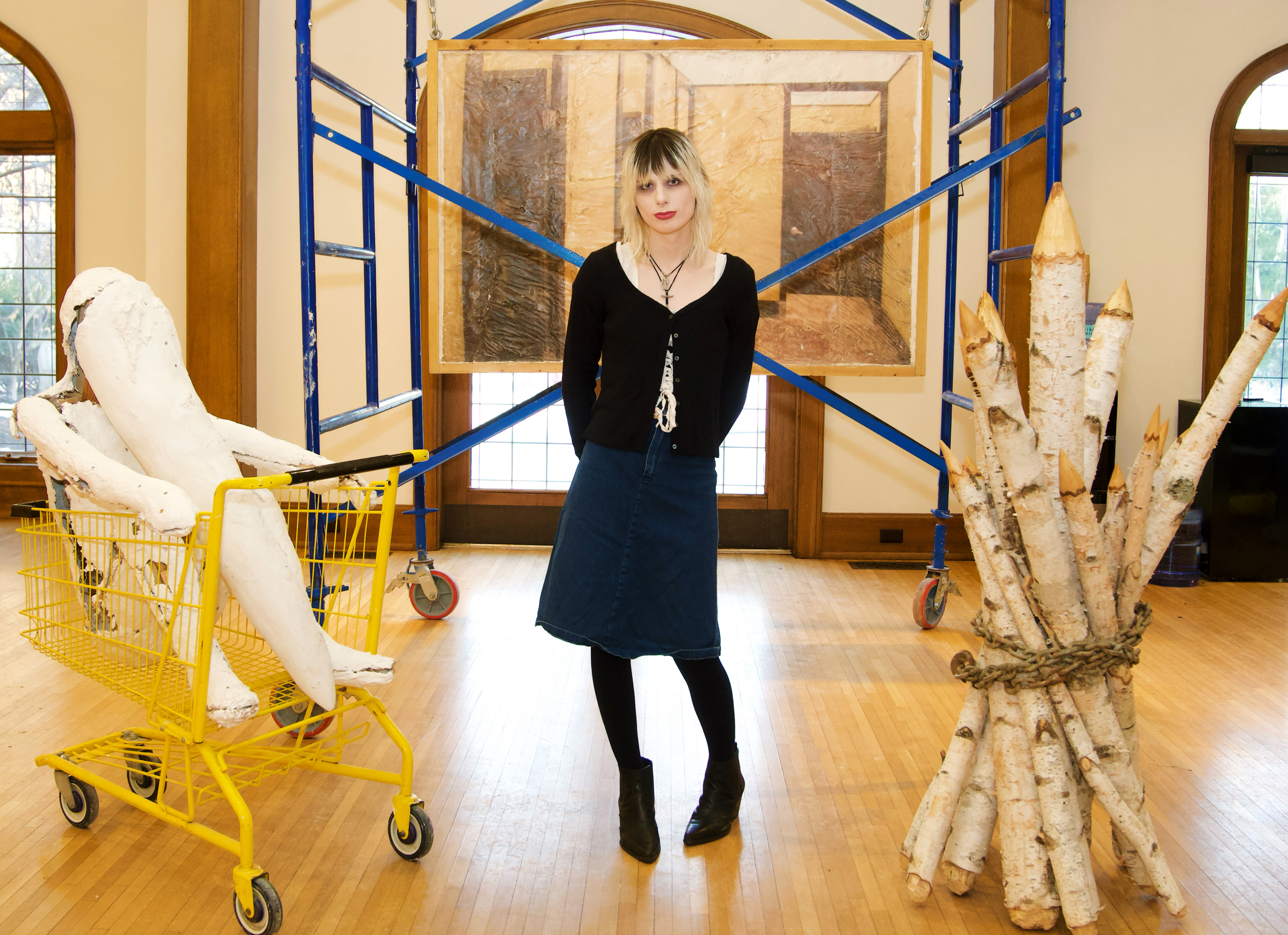 Alex Death in front of her art